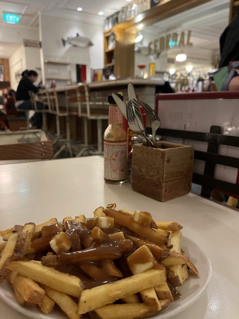 Poutine: a French Canadian classic of hot chips, covered in gravy and curd cheese - salty, melty, combination of crispy and soggy...